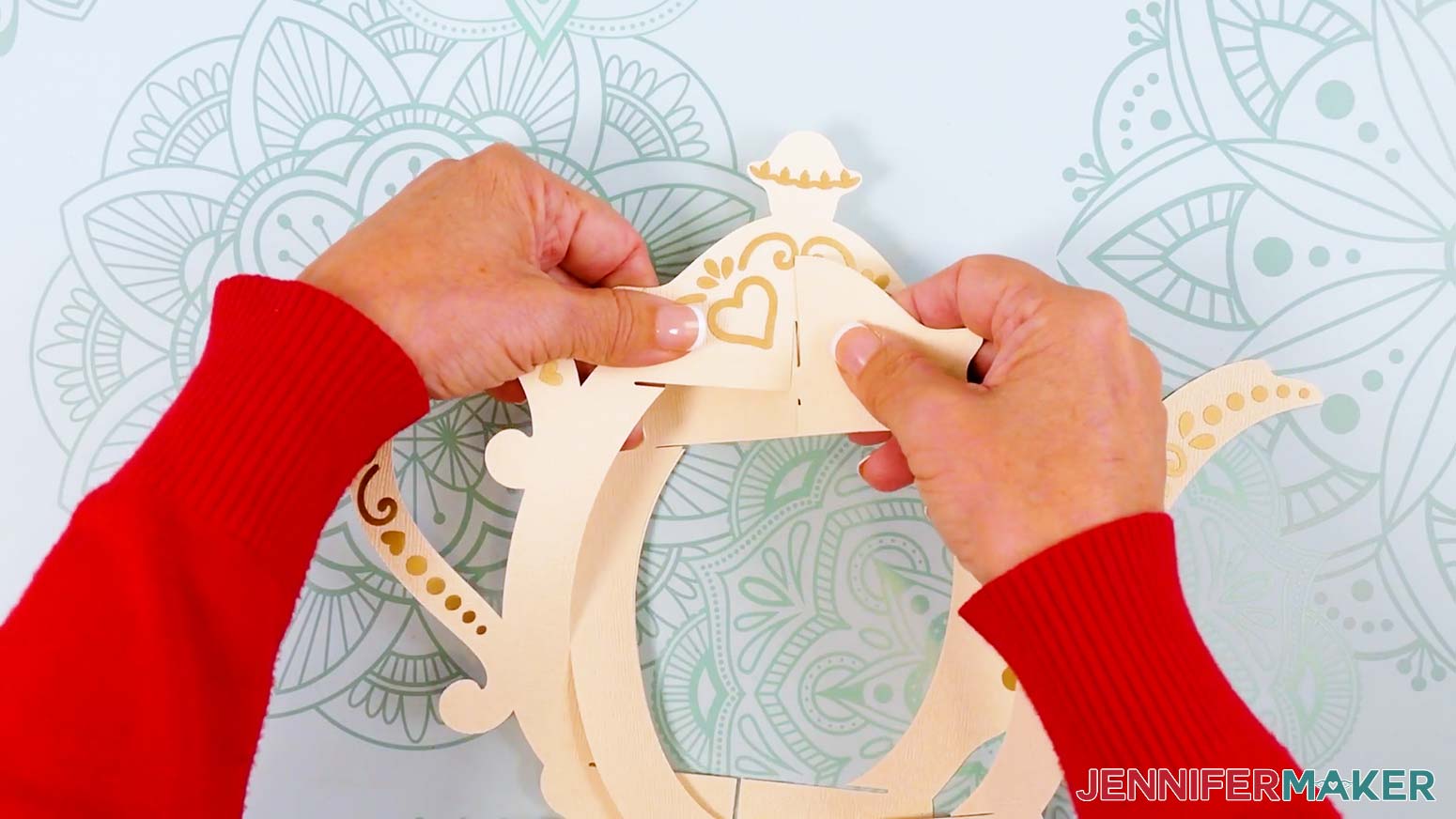 Lay the two frame pieces flat against each other, then slot them into the teapot-shaped frame piece.