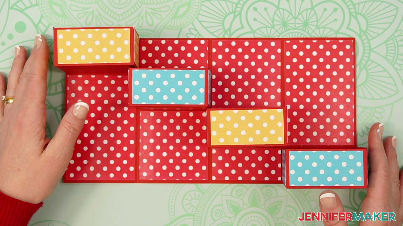 Adhere the inner decorative panels above and below the drawers in the tower gift box.