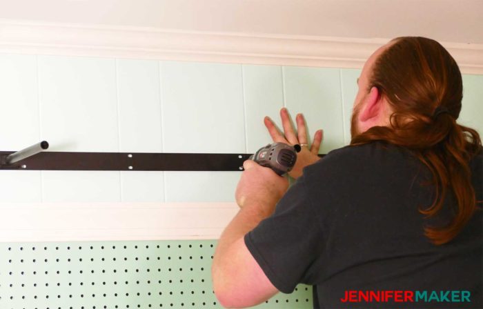 Attaching the floating shelf bracket hardware to the wall with a cordless drill - how to install under shelf lighting cheap and easy