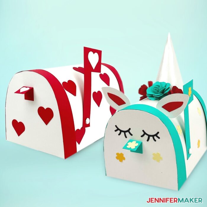 Two white Valentine Mailbox Crafts, one with red heart details and another with blue trim and decorated to look like a unicorn on a light teal background.