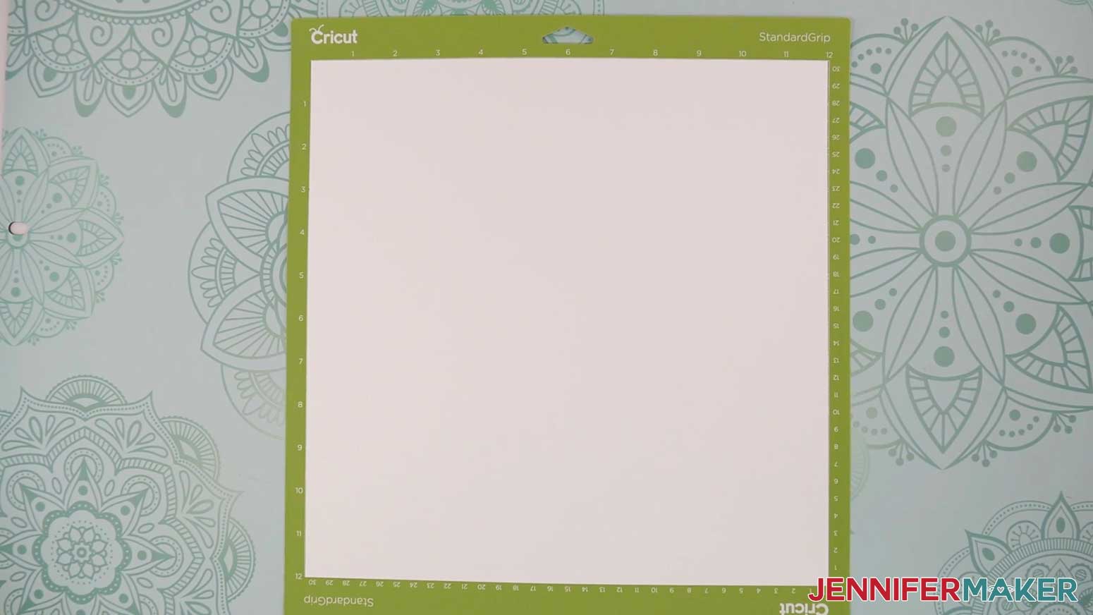 Add the cardstock for the Village Shadow Box With Lights layers to the green StandardGrip Machine Mat.