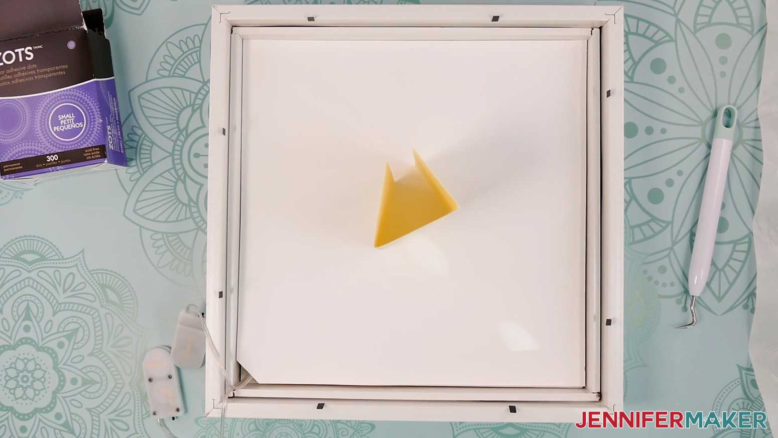 Create a cardstock spacer shaped like a triangle to add to the back of the Village Shadow Box With Lights.