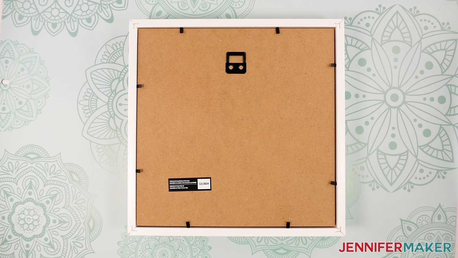 Place the frame for the Village Shadow Box With Lights face down with the top of the frame oriented correctly.