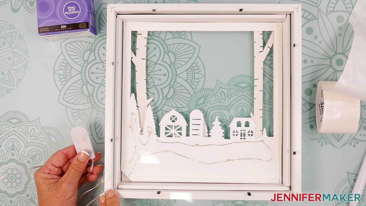 Add the light strip to the back of Layer 3 of the Village Shadow Box With Lights.