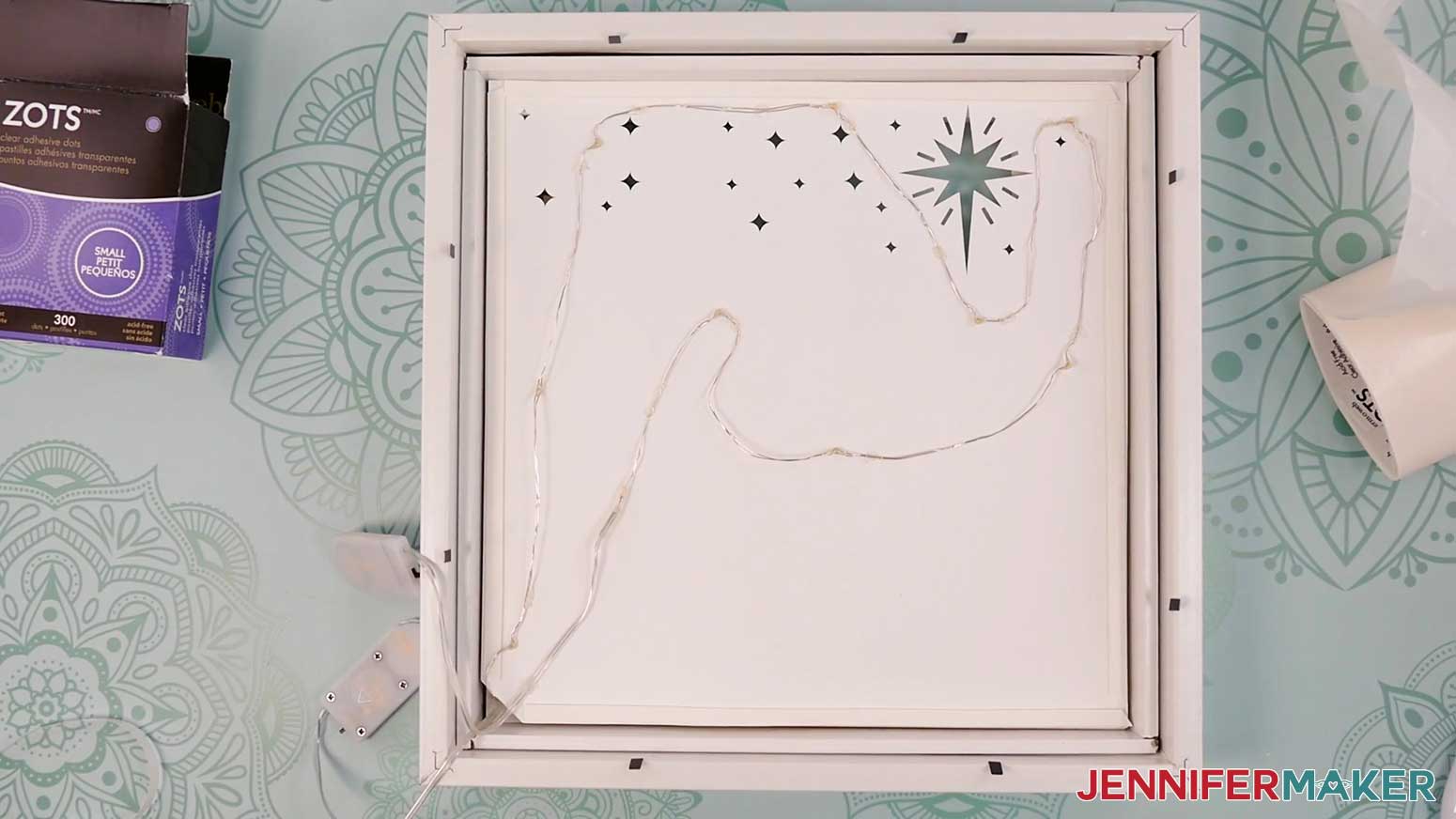 Add the light string to the back of Layer 6 of the Village Shadow Box With Lights.