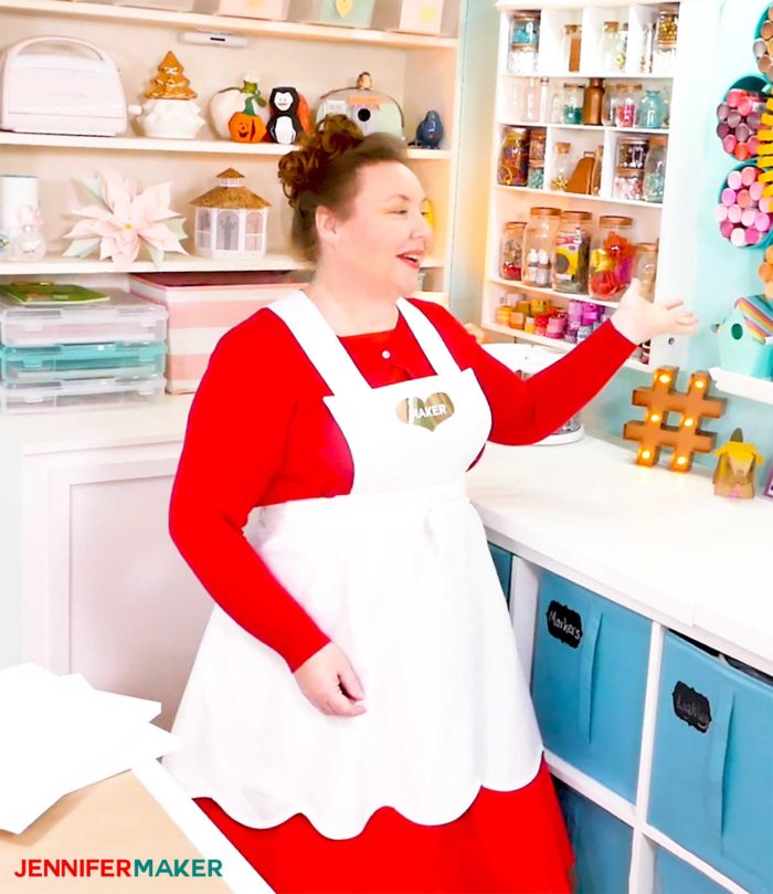 Vintage style white apron over a red dress and sweater