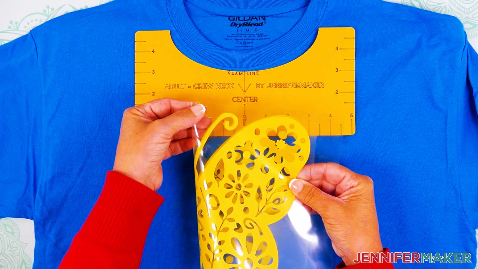 Fold the design and carrier sheet in half and press a crease to the top and bottom to help center the vinyl vs iron on design.