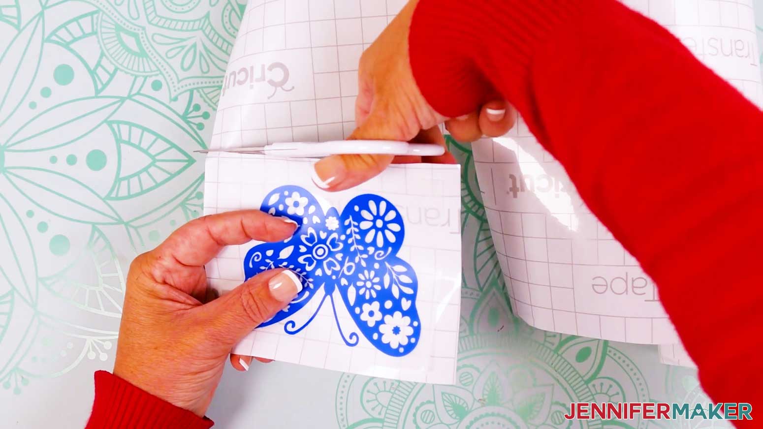 Trim the transfer tape and carrier sheet to a smaller size to prepare to apply the vinyl vs iron on design.