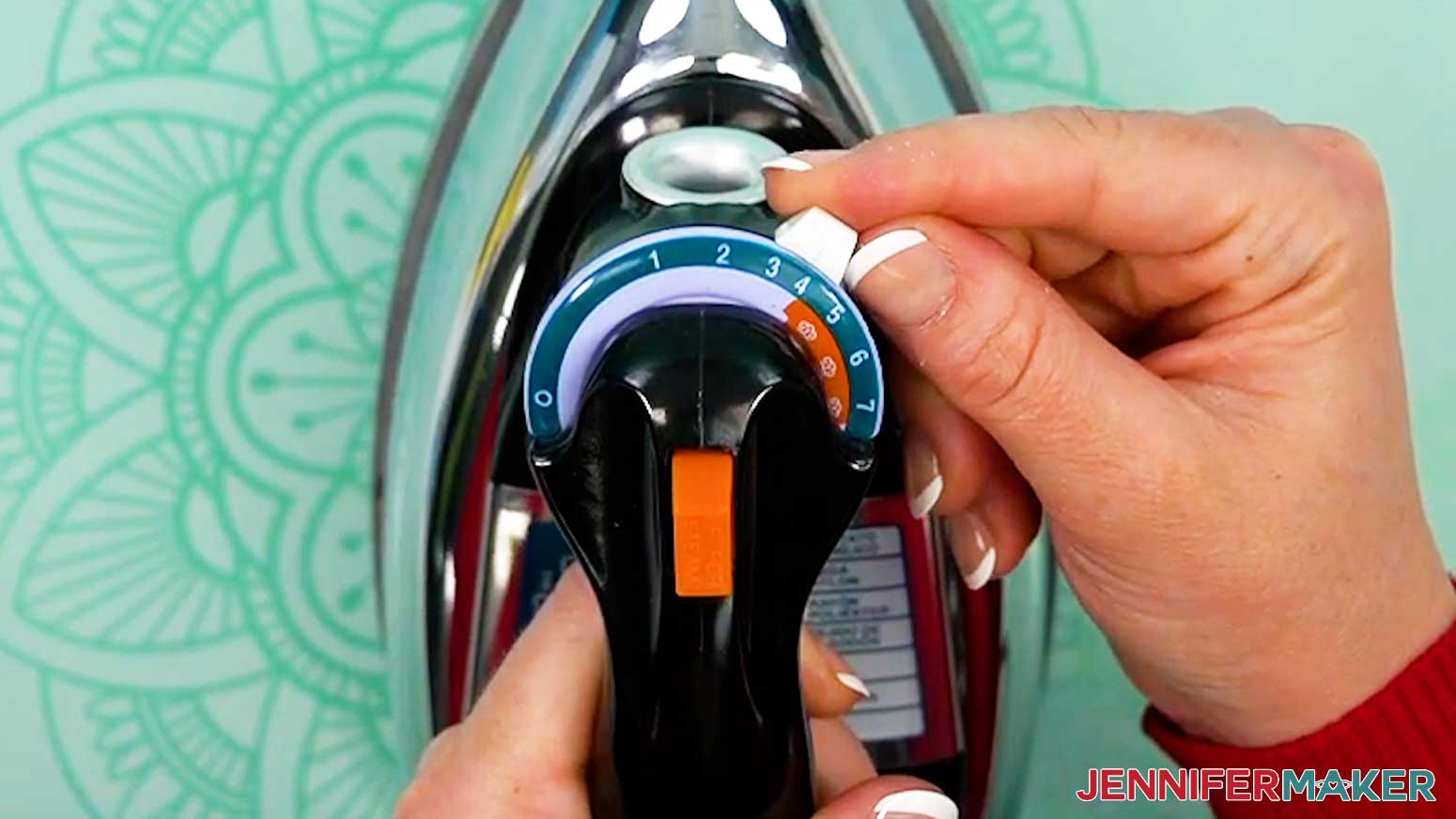 Use the heat setting on a household iron that is closest to the recommended heat press temperature for the material being pressed for the vinyl vs iron on design.