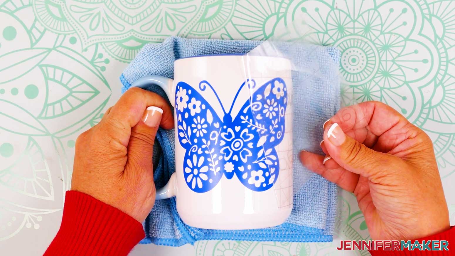 Carefully peel the transfer tape from the butterfly vinyl vs iron on design and mug.