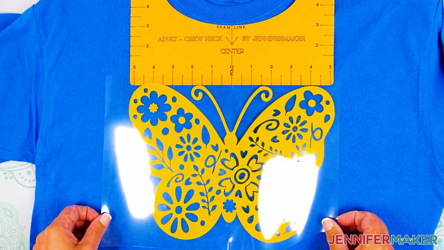 Place the butterfly vinyl vs iron on design onto the shirt using the center creases and t-shirt guide.