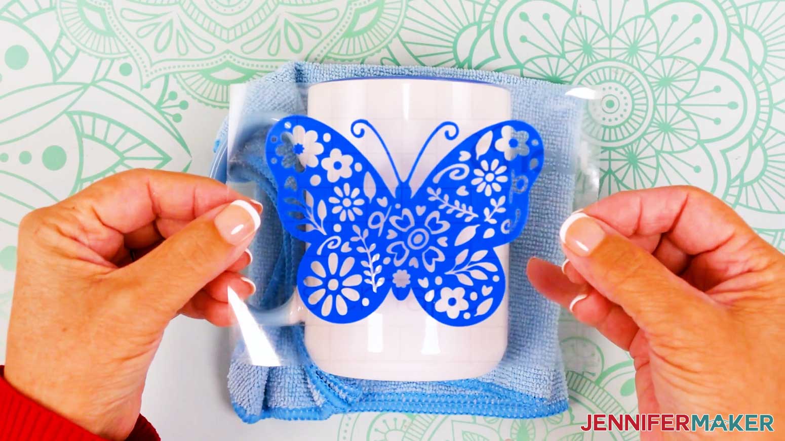 Position the butterfly vinyl vs iron on design over the mug.