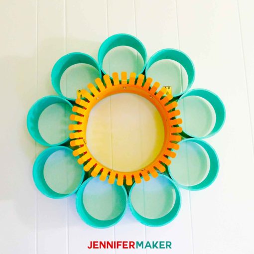 A wallflower made of PVC pipe and a yellow-painted duct collar ring