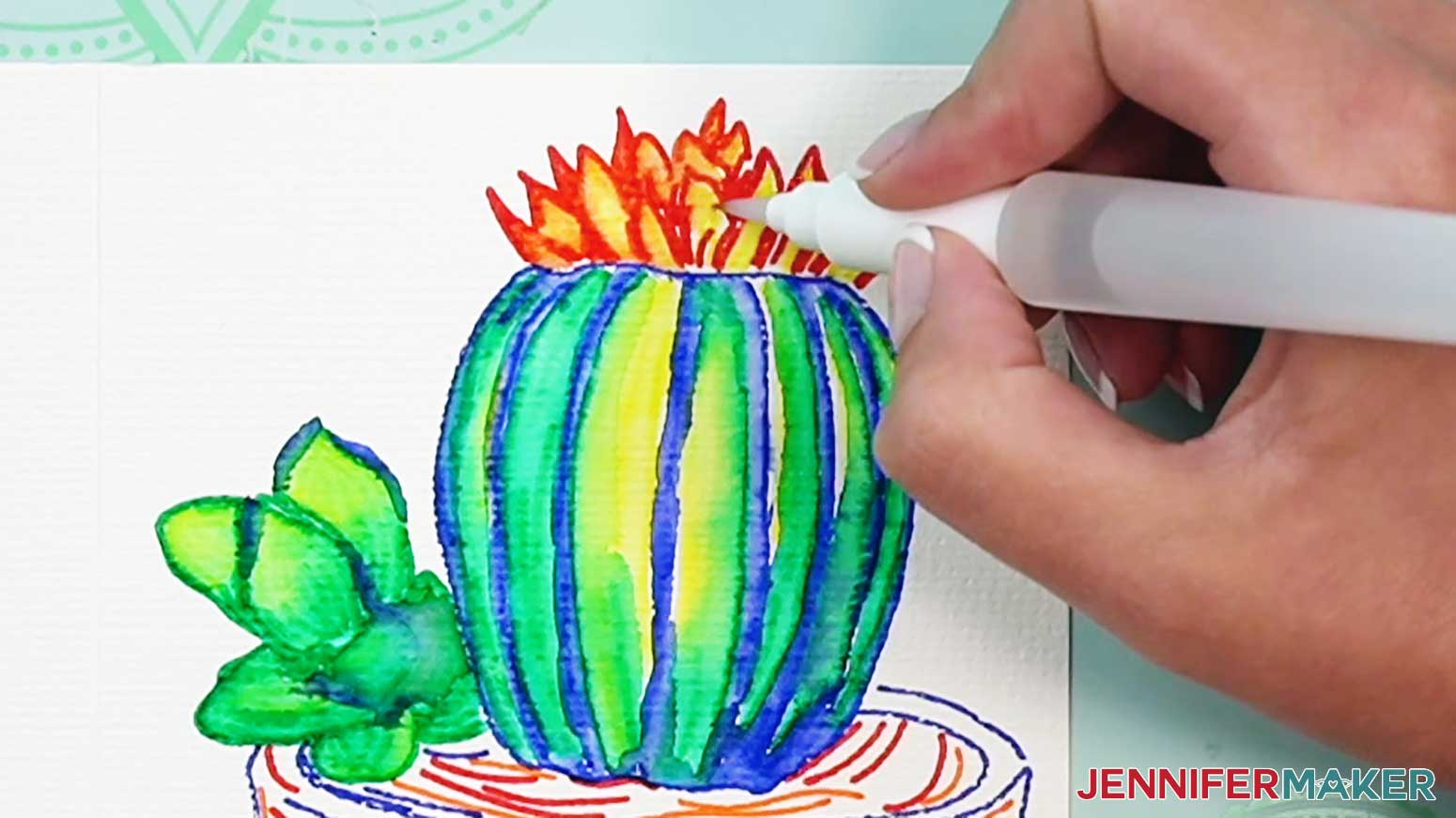Blend the orange lines into the yellow to create depth of color at the top of the watercolor cactus.