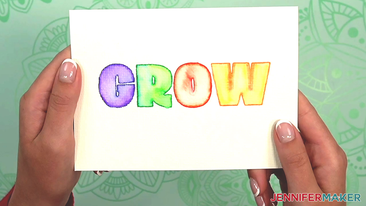 The watercolor warmup word GROW is completely colored in and ready to gift as a card.