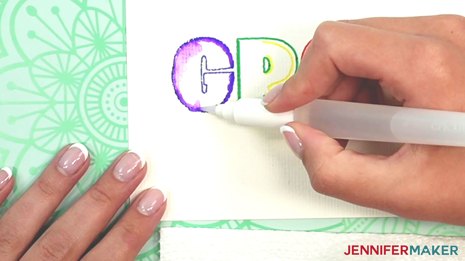 Blend the blue color on the edge of the letter G in the Watercolor GROW word by adding water with the brush and brushing in toward the center of the letter.