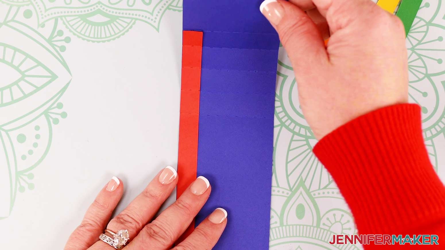 When the waterfall card's red rainbow stripe is attached to the slider piece correctly, the fold lines will match up.