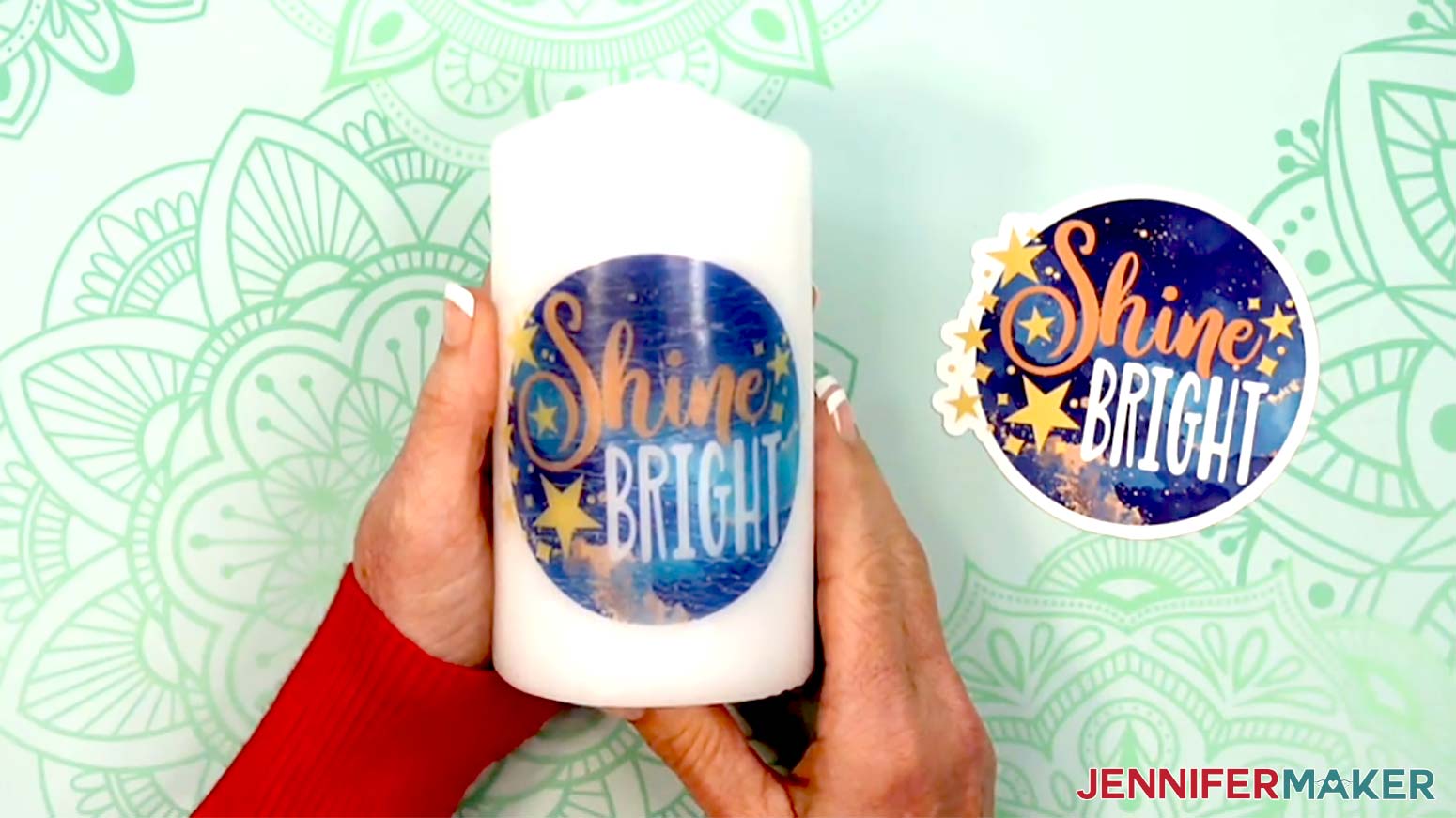 The candle is shown with one decal applied and a second decal of the same design trimmed and ready to apply.