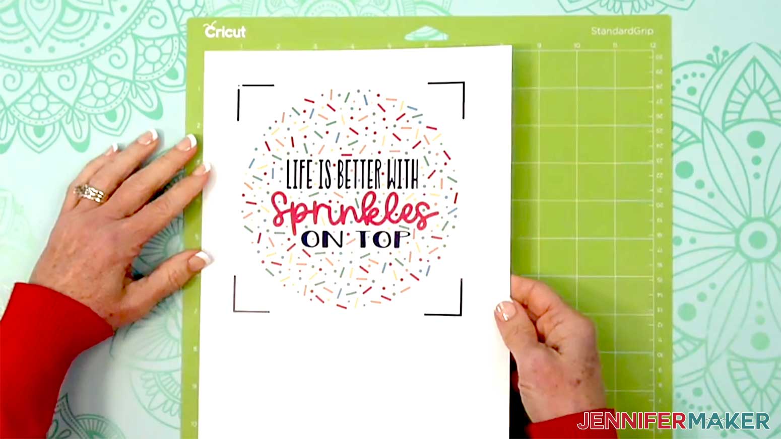 The printed sprinkles waterslide decal paper is being placed on a Green Cricut Standard mat.