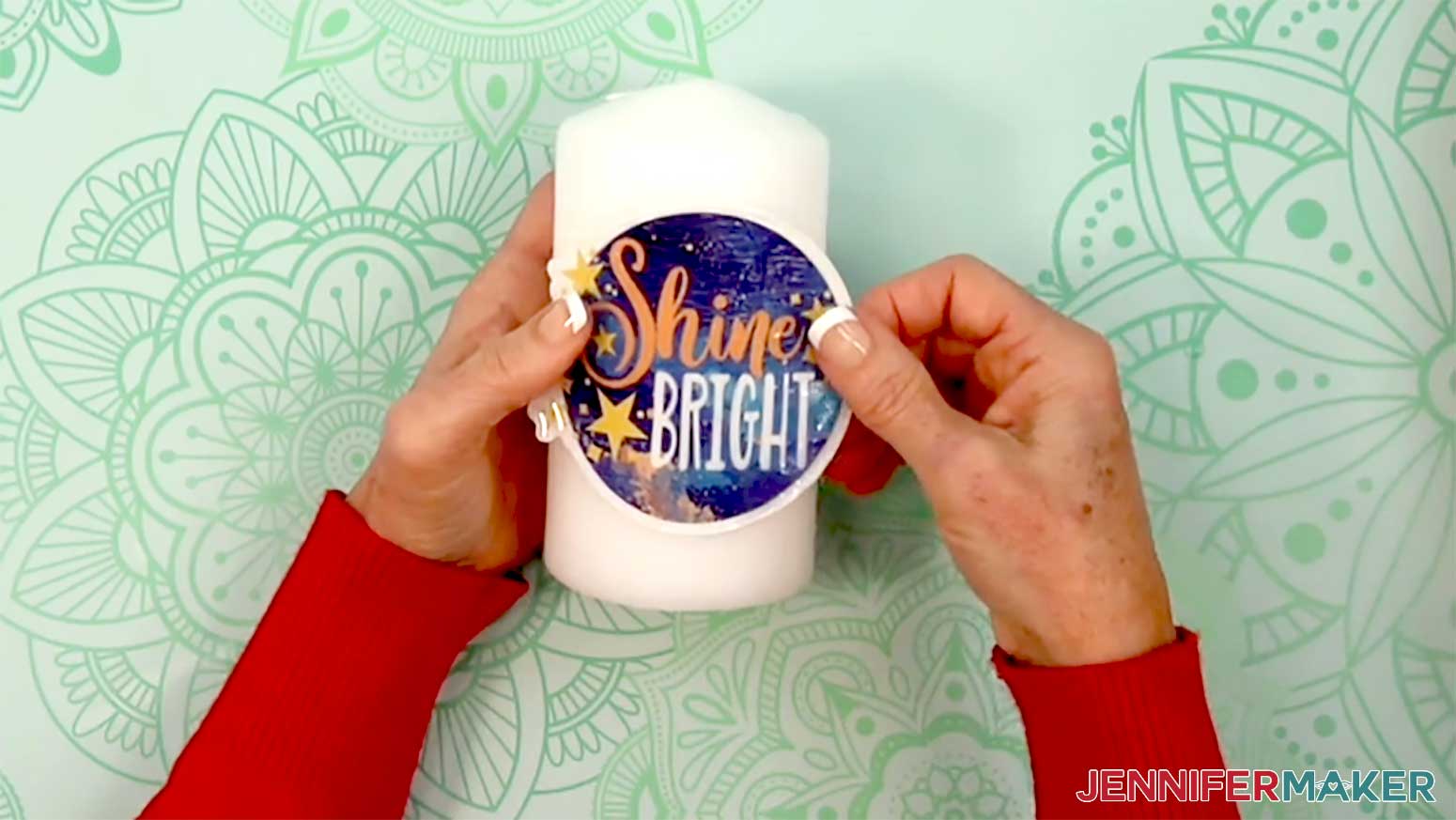 The shine bright waterslide decal is being positioned in the middle of the candle.