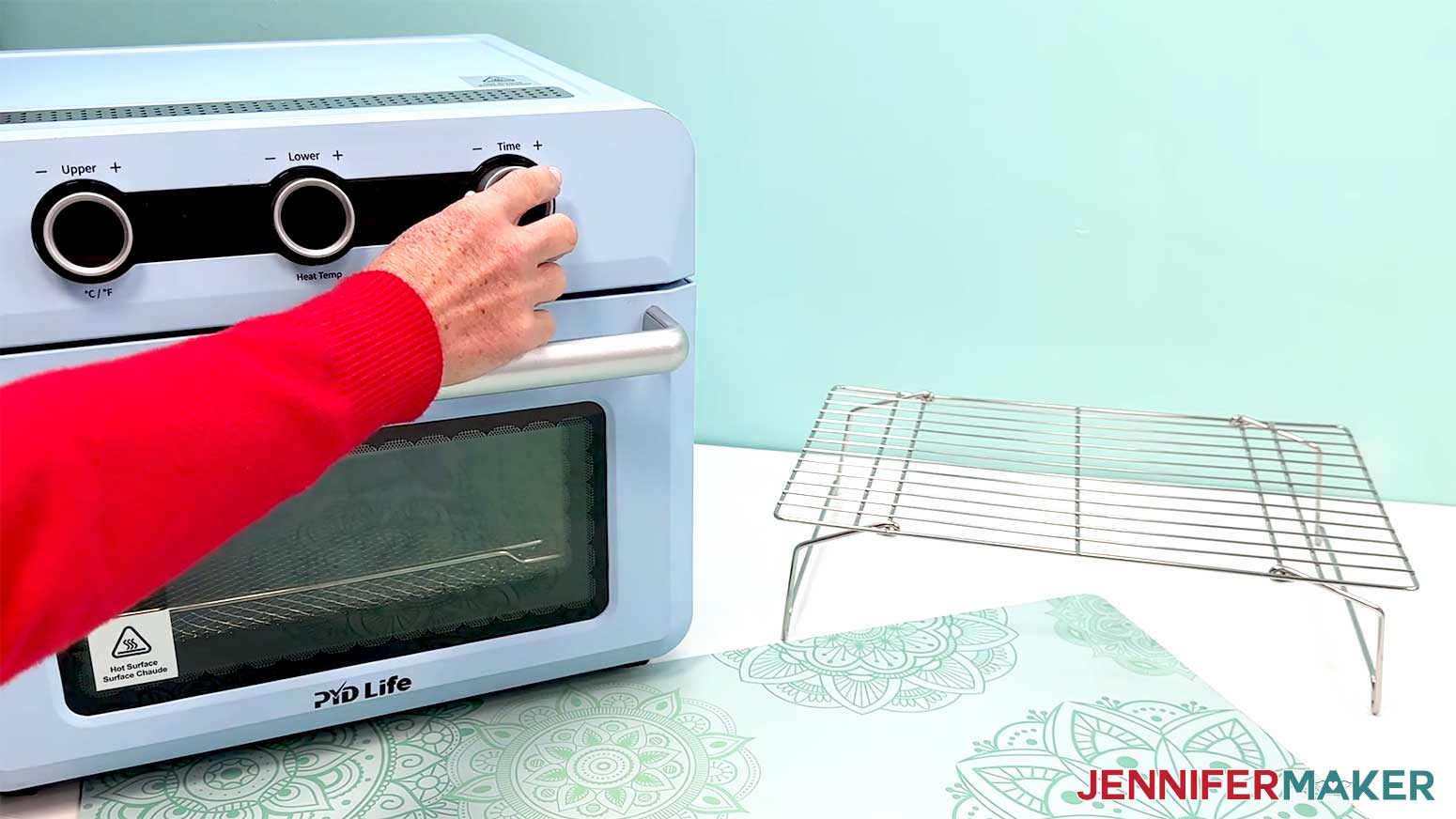 The oven is being set to the correct settings for sealing the waterslide decal to the plate.