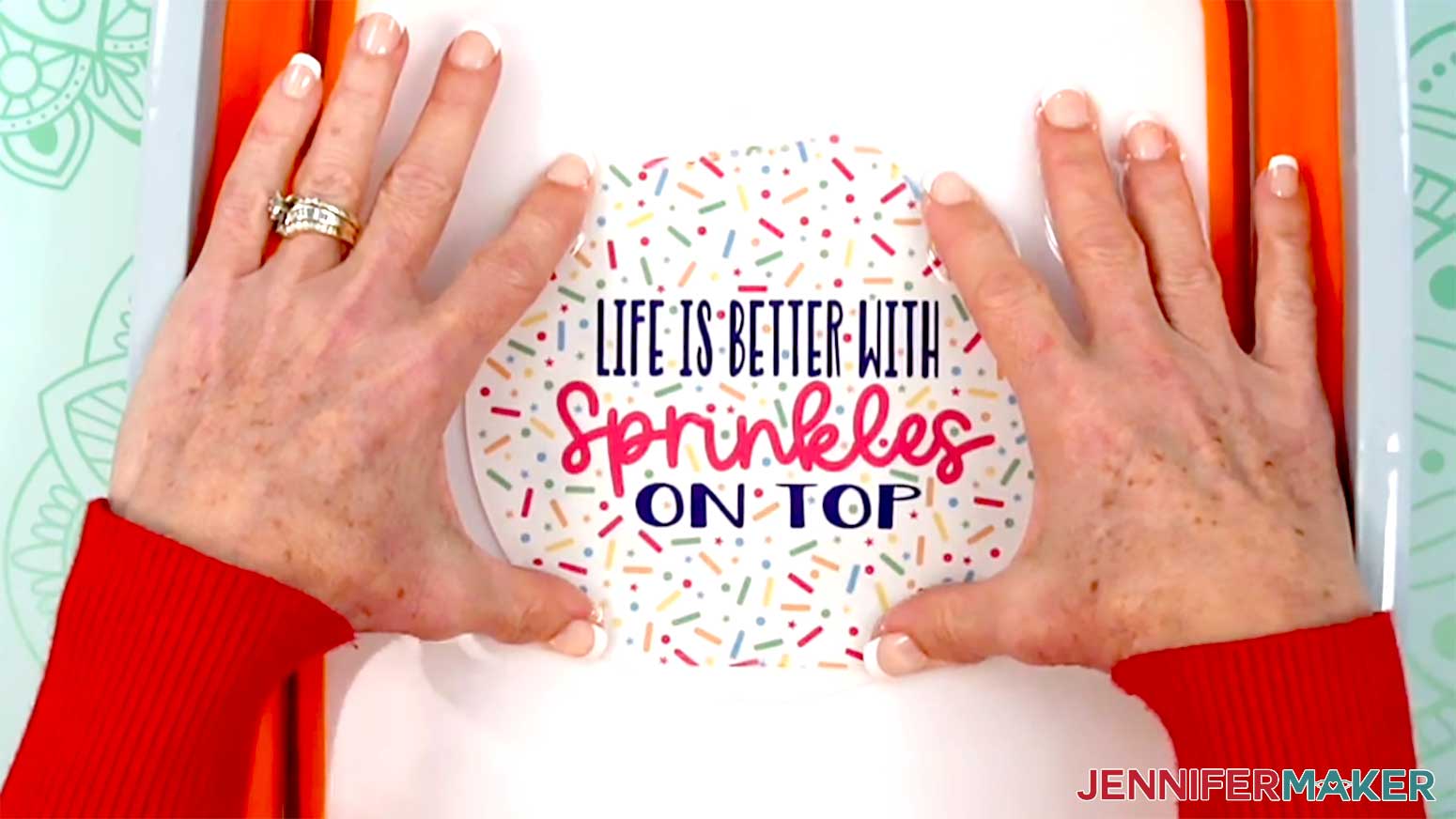 The sprinkles waterslide decal is being soaked in water in a bowl big enough that it stays very flat.