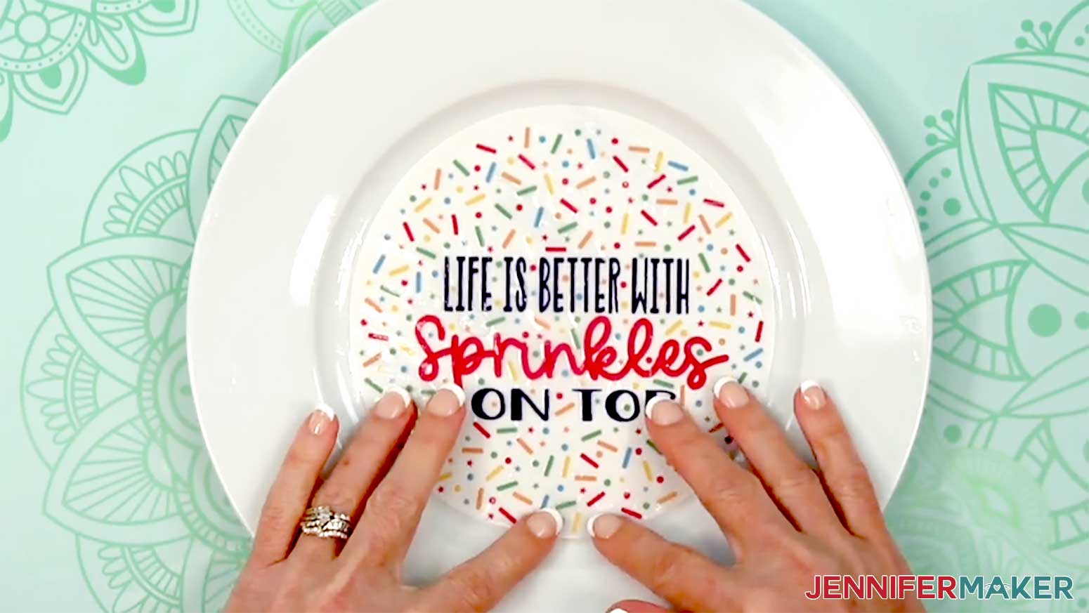 The sprinkles decal is being applied to the plate still wet.