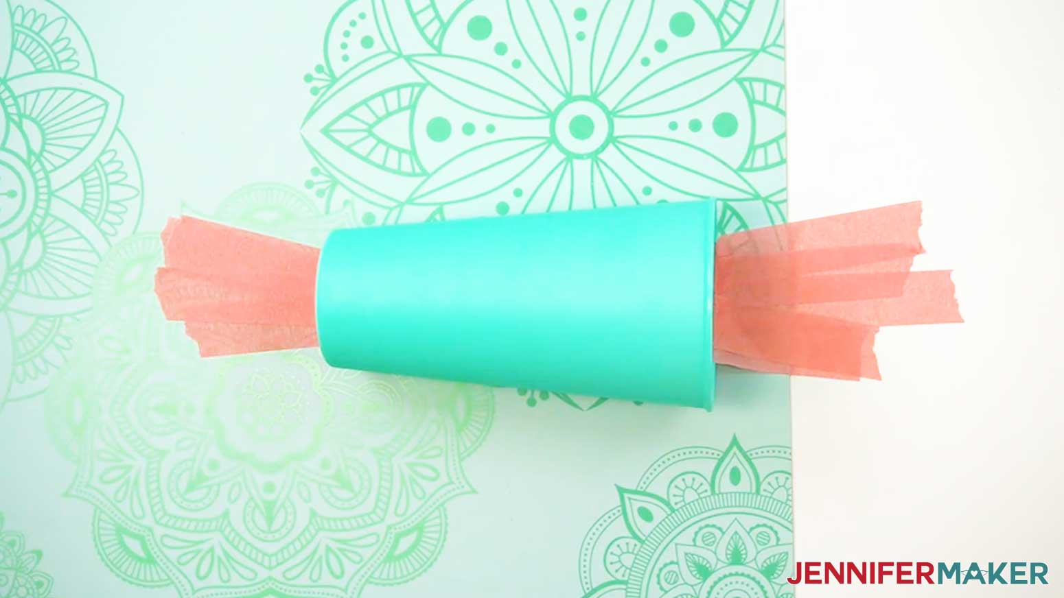 Tape the light weight cup to the work surface to prevent it from moving when applying the UV DTF design.