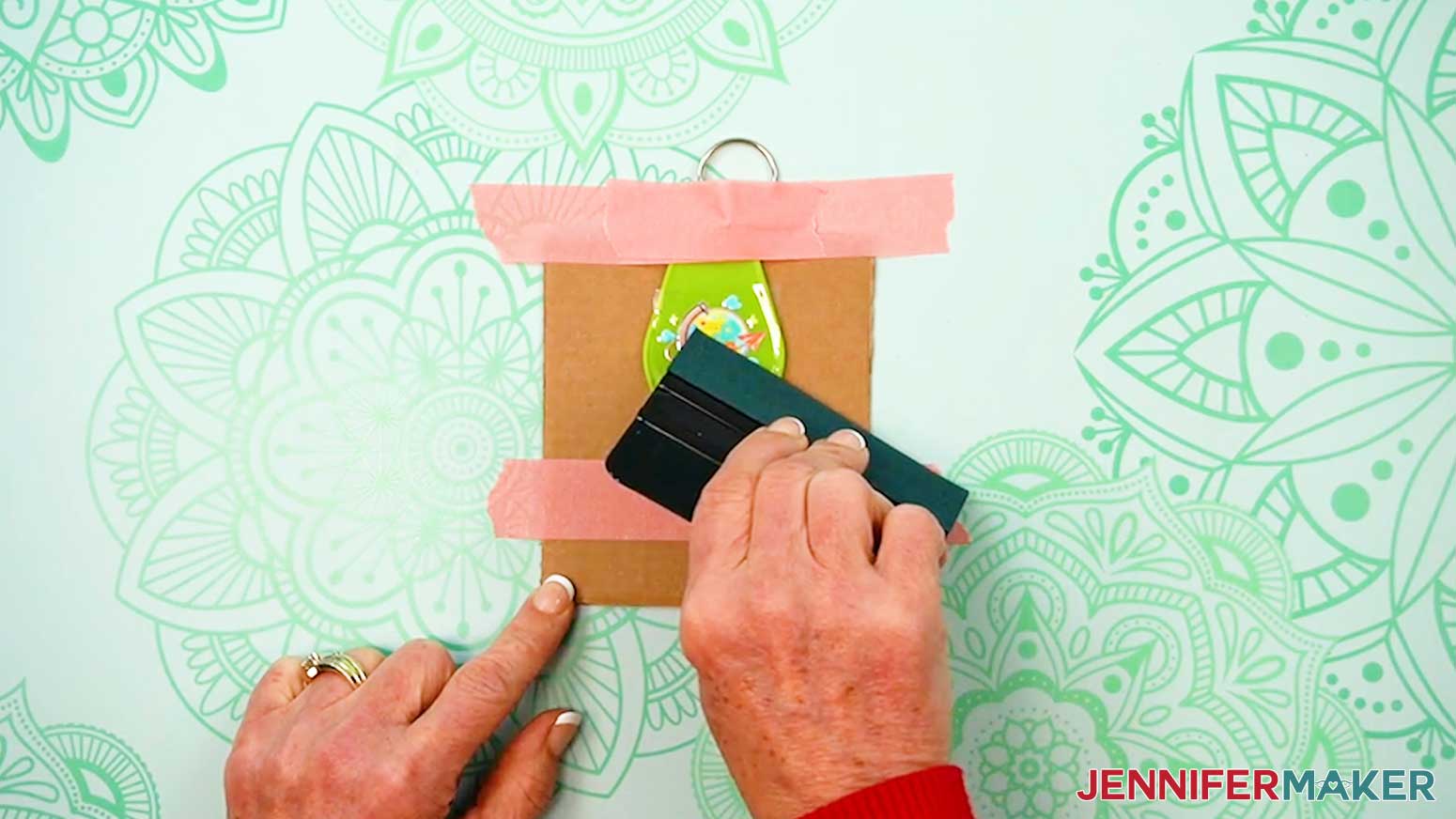 Use a squeegee to fully adhere the UV DTF Design to the blank.