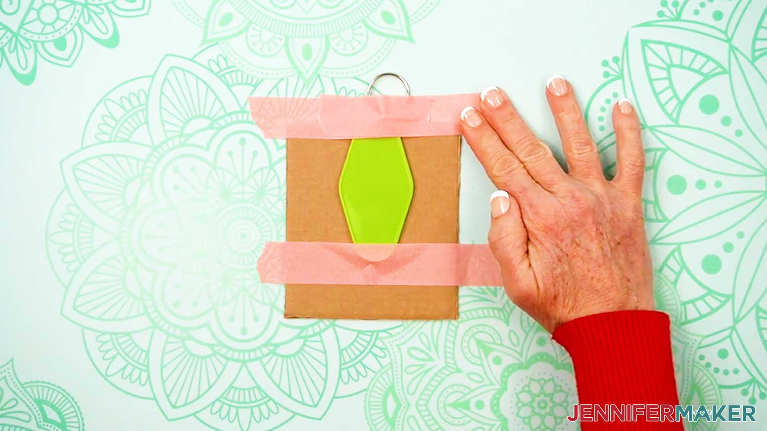 Tape the keychain onto a raised surface to keep it flat for the application of the UV DTF Design.