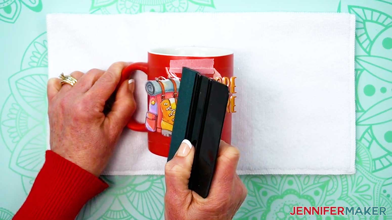 Use the squeegee to fully adhere the UV DTF design to the mug.