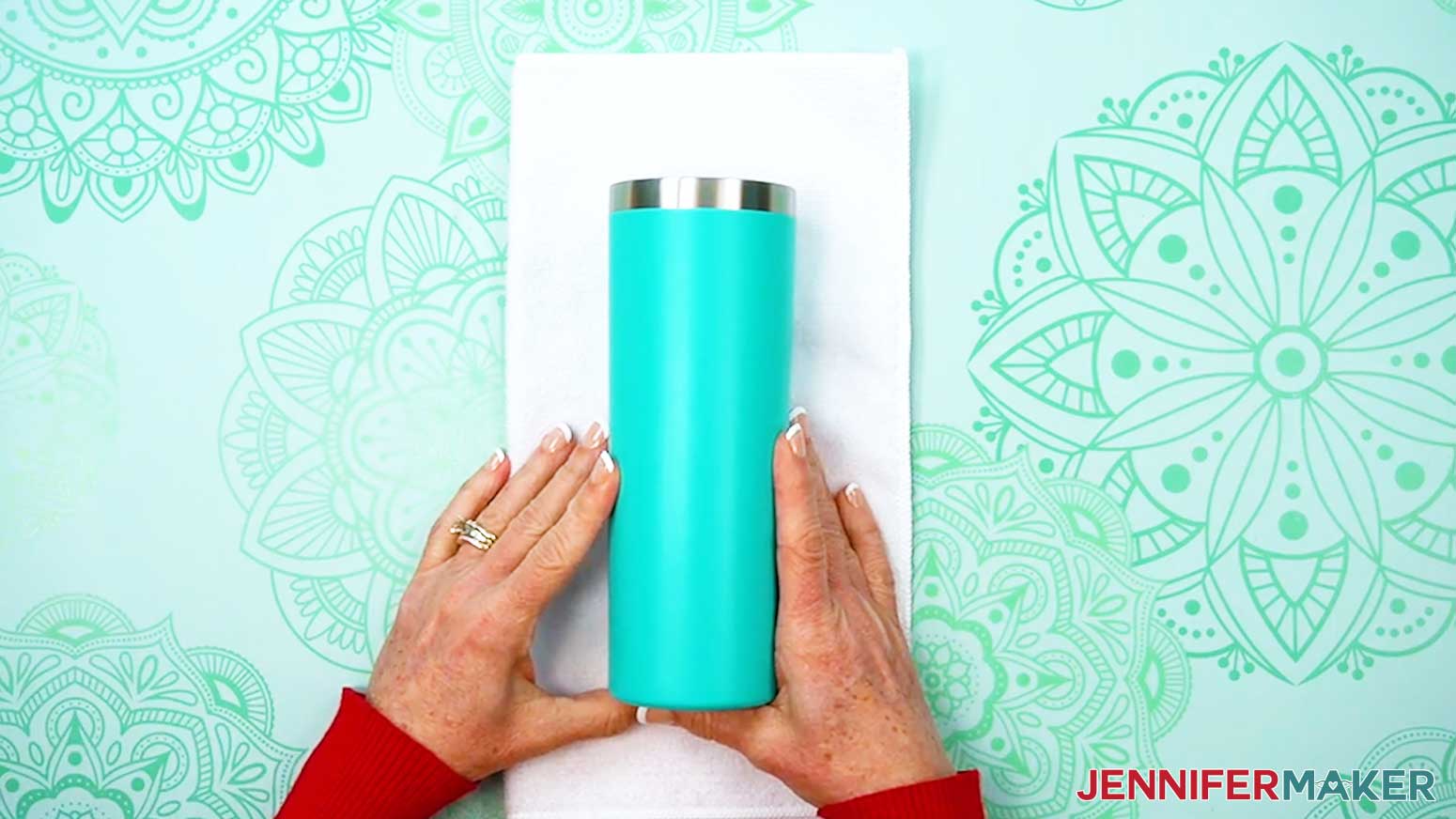 Place the tumbler onto a towel to help hold it in place while applying the UV DTF design.