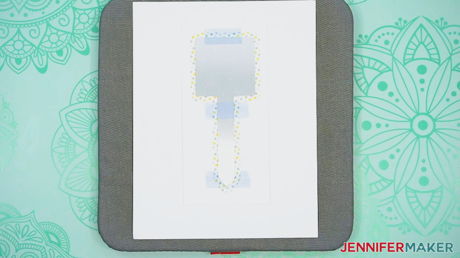 Place the print and taped sublimation garden stake design onto the blowout paper and pressing pad.