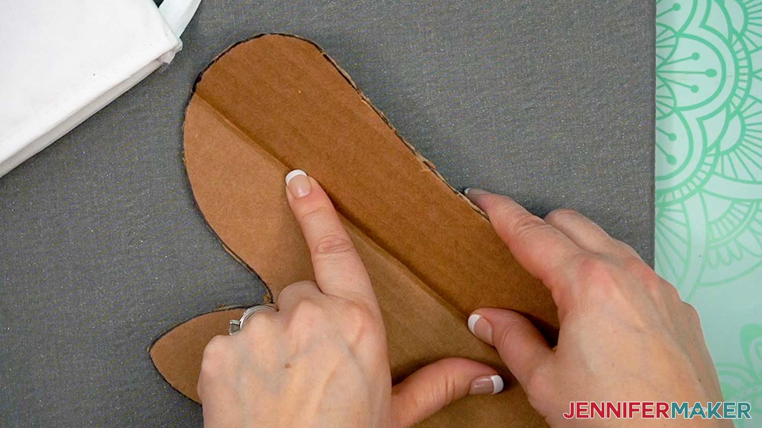 Slightly fold the insert at the longest part to fit it into the opening of the Sublimation Oven Mitt.