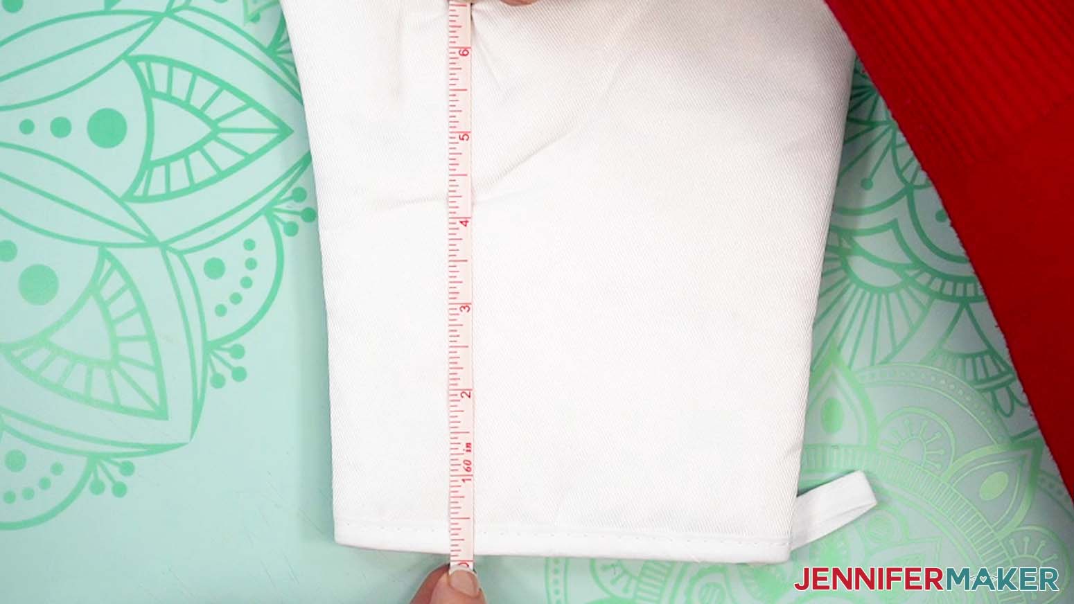 Measure the dimensions of the oven mitt to verify the design will cover the surface.