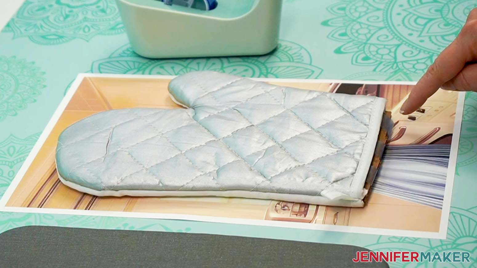Position the oven mitt face down onto the design.