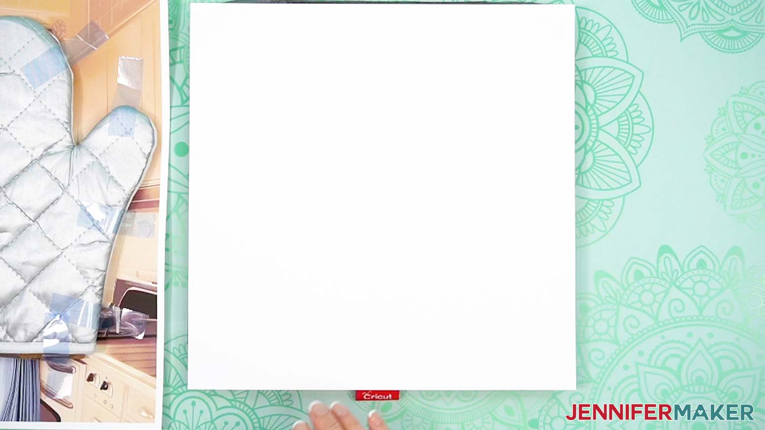 Place white cardstock onto the pressing pad for sublimating the oven mitt.