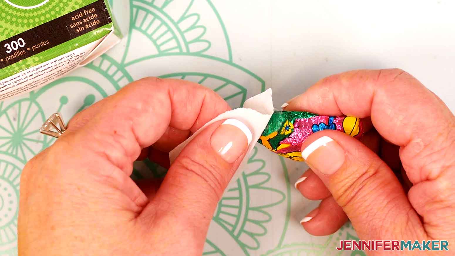 Apply two small glue dots to the bottom of a piece of candy.