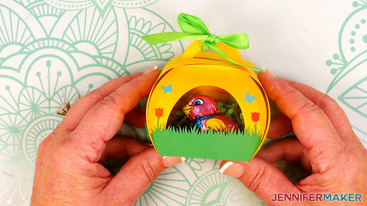 Tie the box closed with a piece of green ribbon.