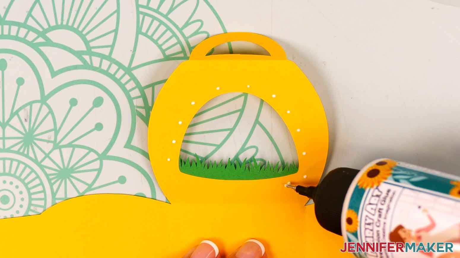 Apply small dots of craft glue around the inside of the window of the treat box.