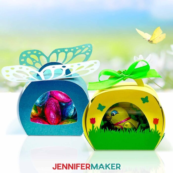 Make cute Window Treat Boxes for spring with the free tutorial and files! A sparkly blue treat box with a butterfly on top and a window show multicolored chocolate eggs inside, and a green and yellow treat box decorated with flowers holds a wrapped chocolate chick