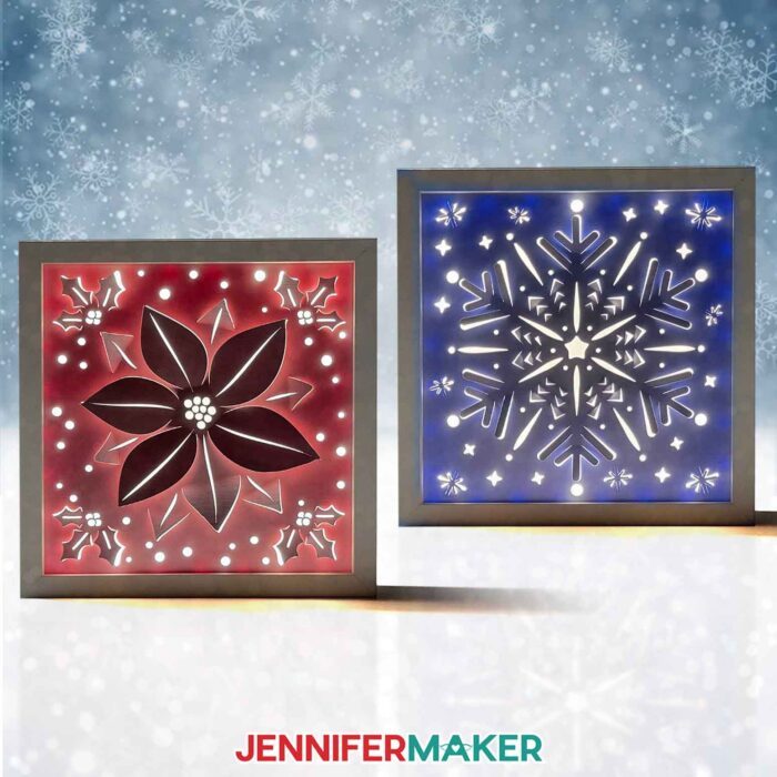 Two Winter Backlit Shadow Box projects sit side by side, one red and one blue, glowing from within through their detailed cutouts