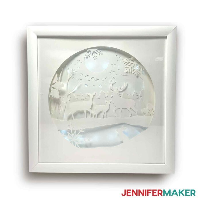 Winter shadow box with scenic forest on white background