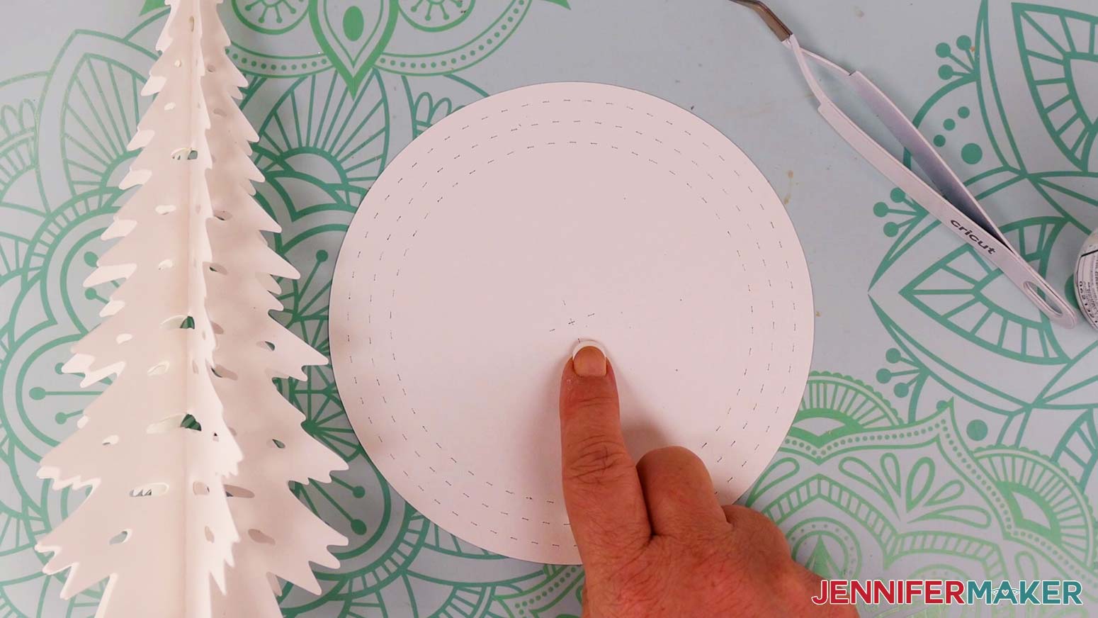 Find the circular base piece. You will notice an “X” shape in the center.