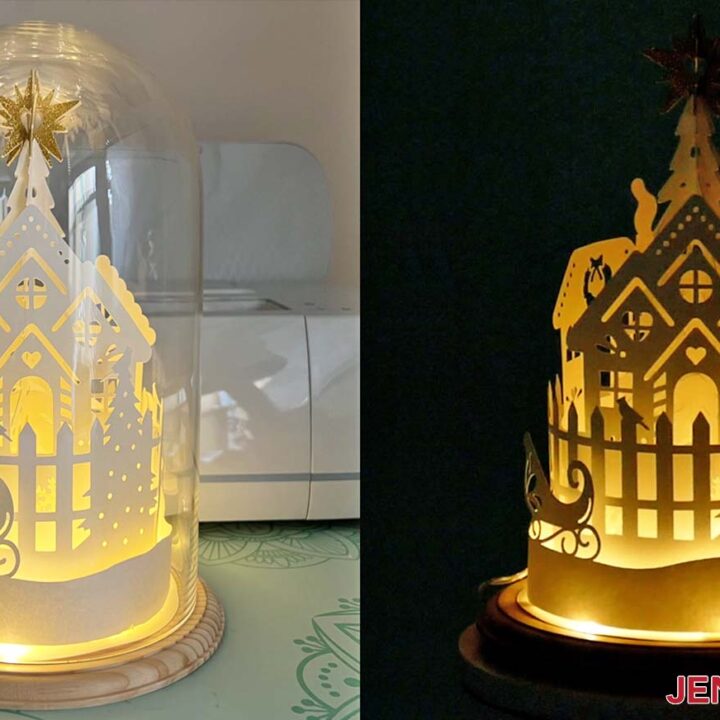 Winter village lantern on display with glass dome and without