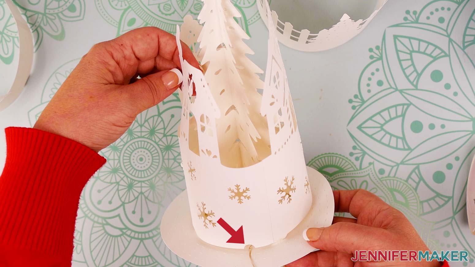 Feed the fairy lights wire underneath the semicircle cutout before securing the tabs on either side of it.