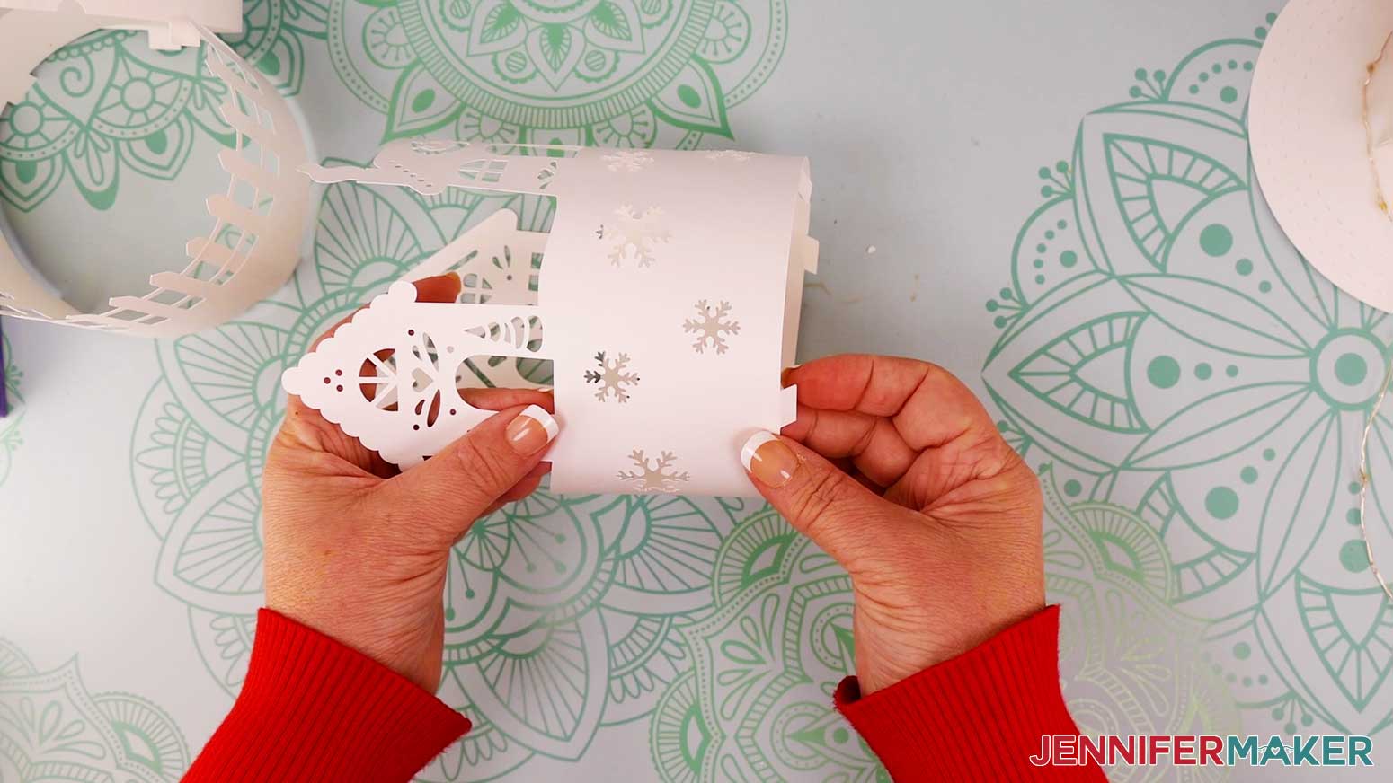 Fold the bottom tabs on each layer inward toward the center of the cylinder