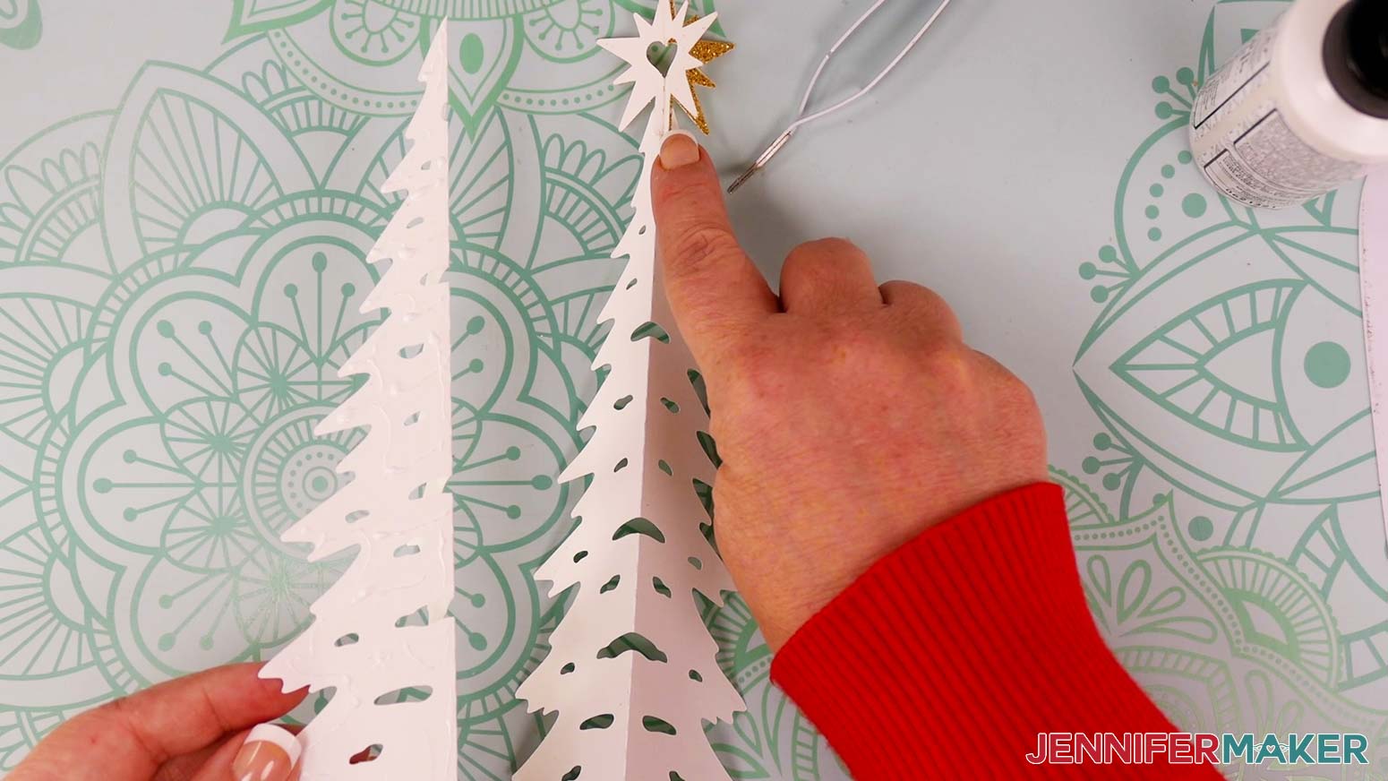Add glue to one half of another tree piece on the back side