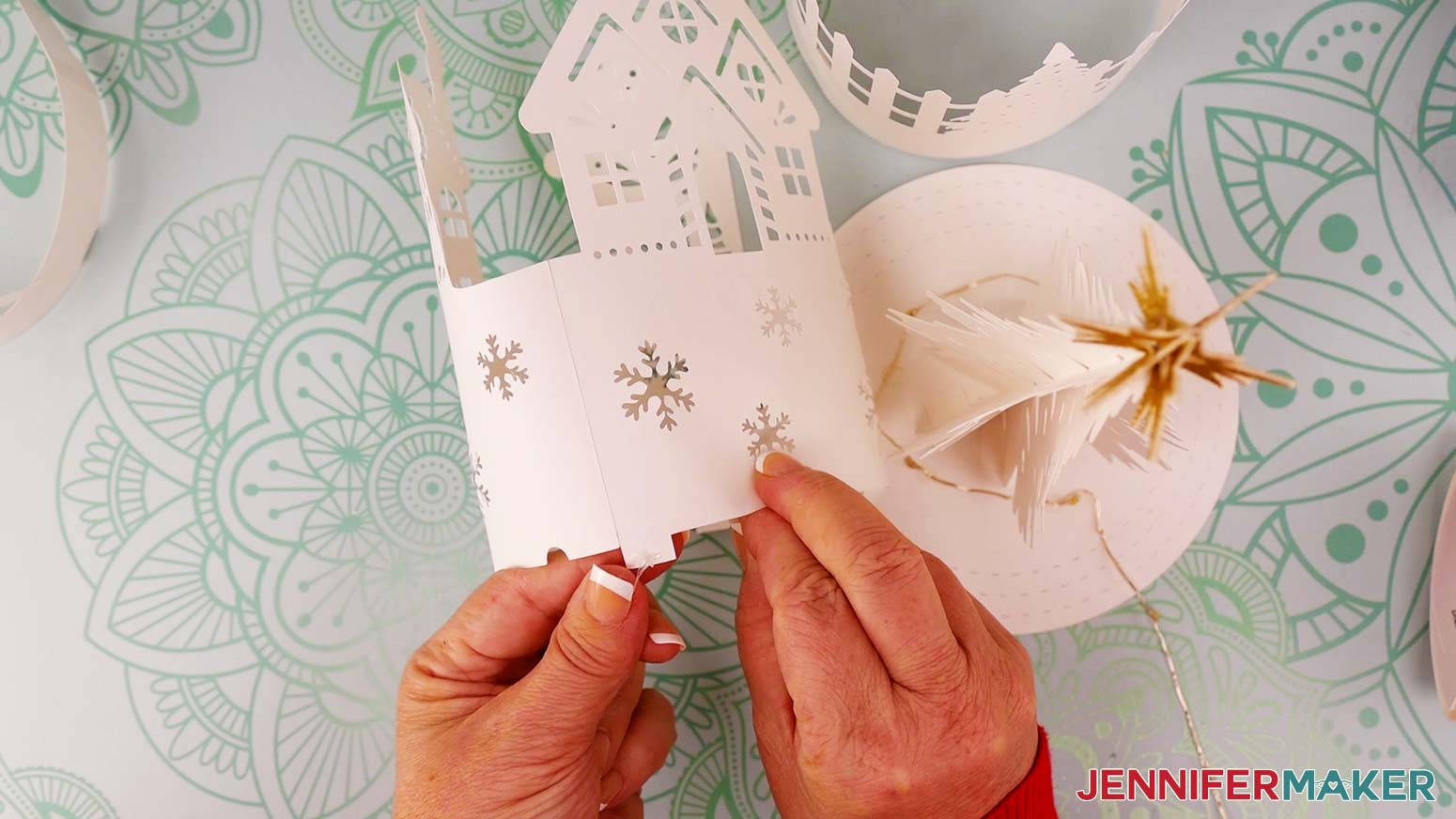 Add glue or glue dots to the bottom of one or two tabs on the innermost (house) layer.