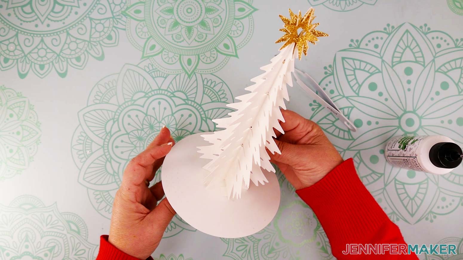 Place the assembled tree in the center of the circular base so it’s lined up with the “X.”
